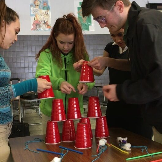 ISY students participating in the Red Cup STEM Challenge during a workshop facilitated by ISY team members.