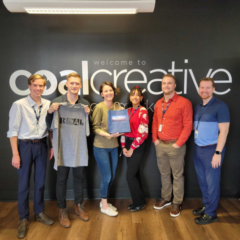 Group standing in Coal Creative office